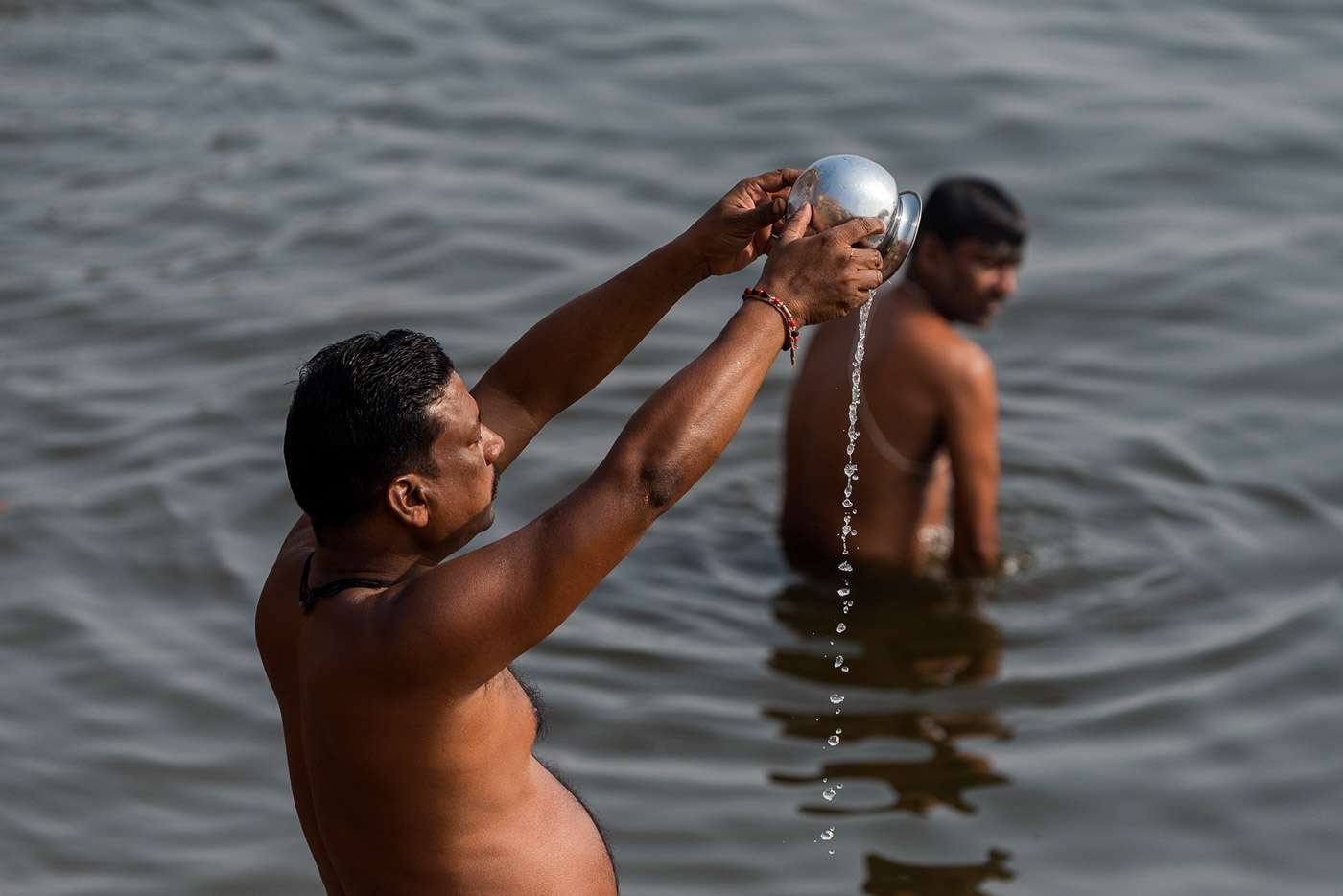 Varanasi, India: Pilgrims bathe and anoint themselves with the sacred water of the Ganges river.